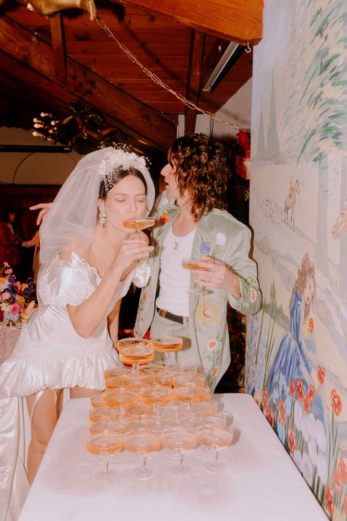 bride and groom drinking champagne 