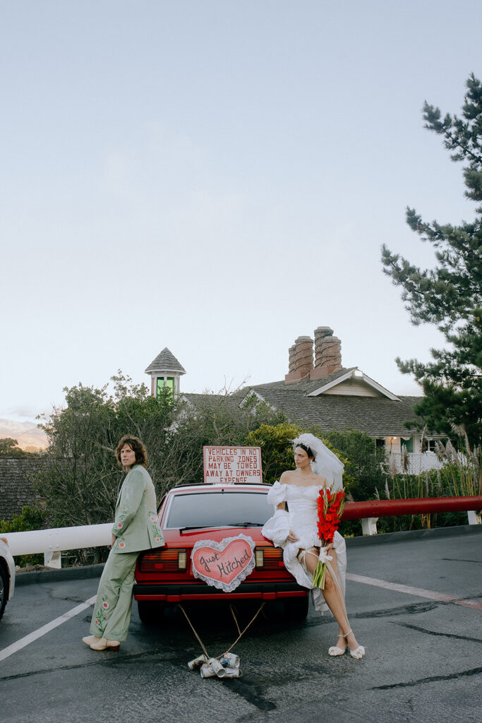 cute picture of the bride and groom with their dream car