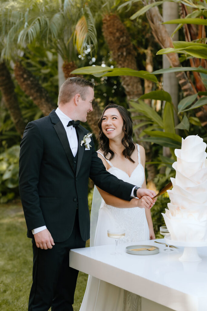 cute couple cutting their wedding cake 