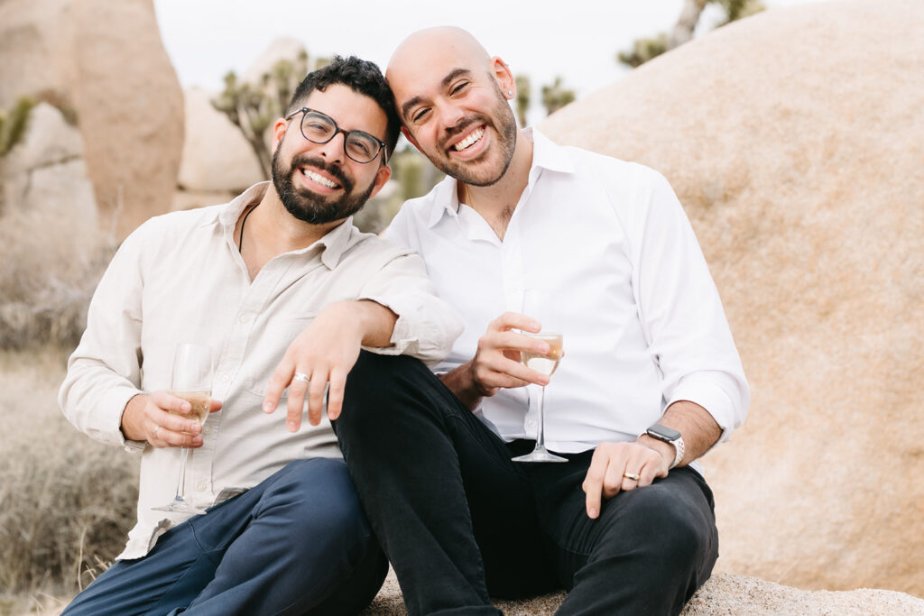 cute couple looking at the camera during their LGBTQ spring proposal