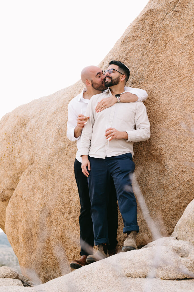 cute fiance kissing his fiance on the cheek after their proposal