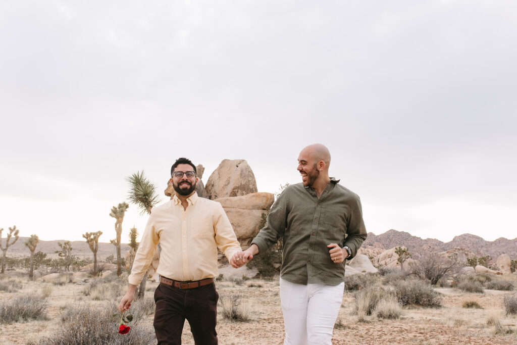 couple walking around joshua tree national park after their engagement 