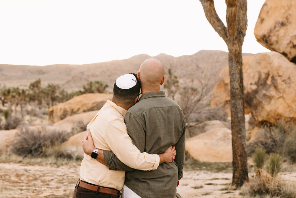 couple hugging admiring the beauty of joshua tree national park