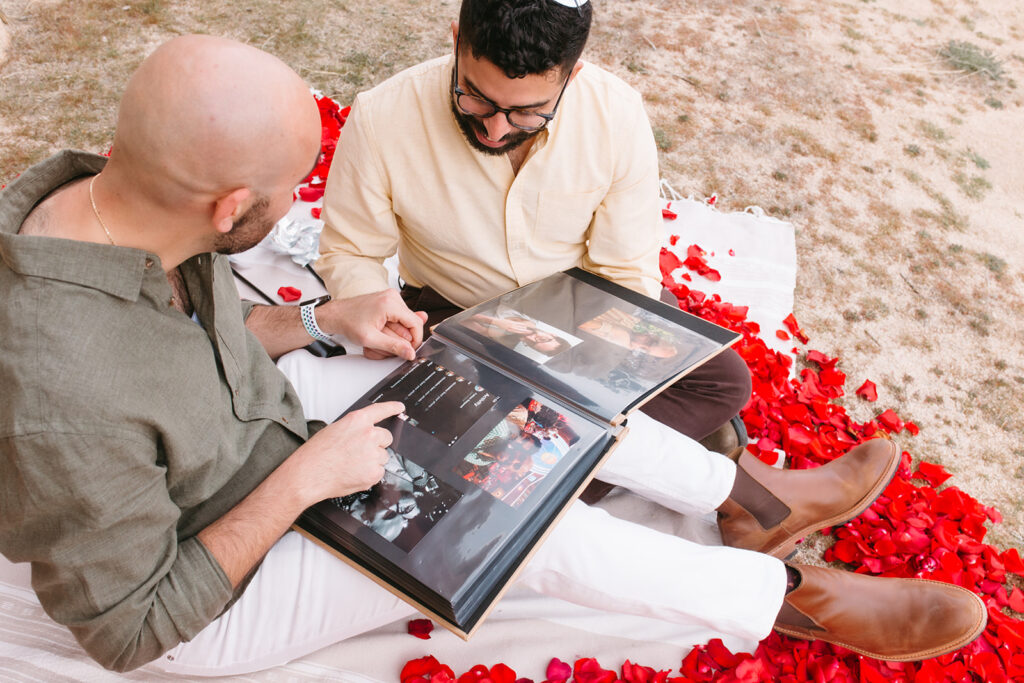 newly engaged couple looking at their adventure album