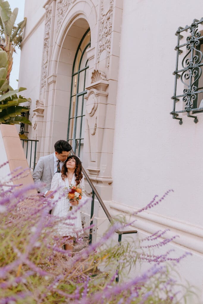 groom kissing the bride on the forehead