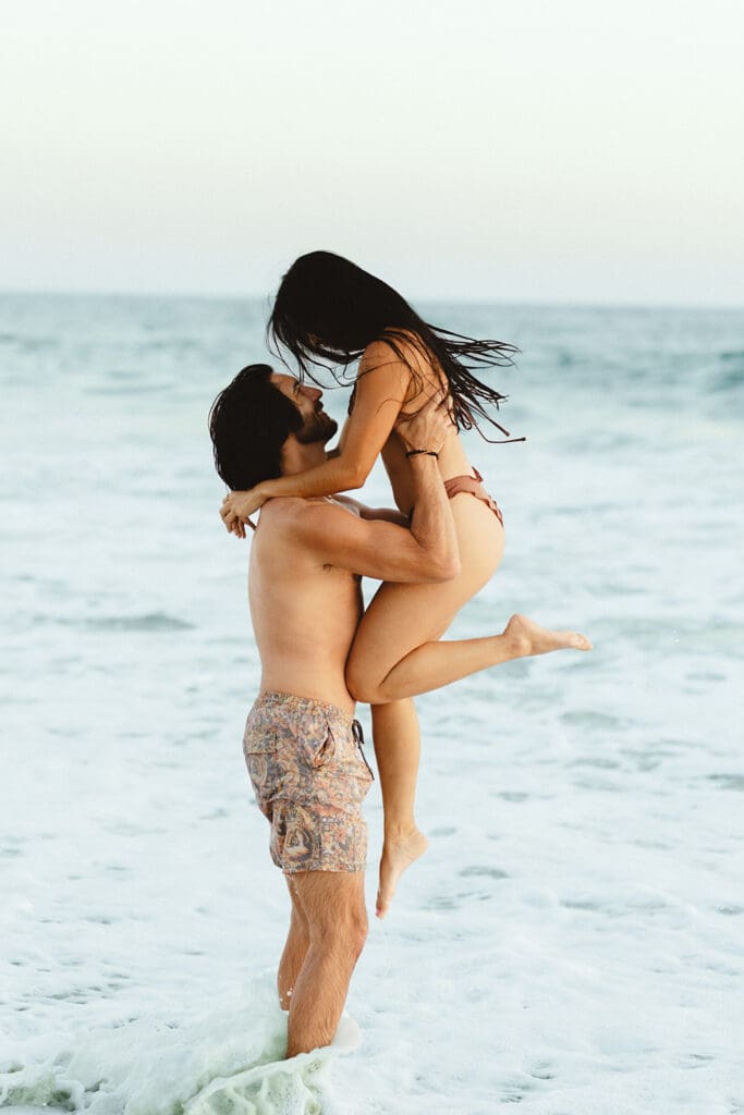 playful engagement photos at the beach