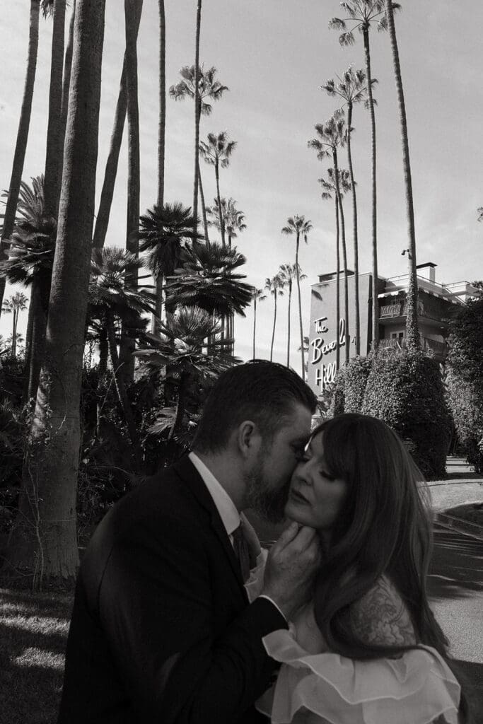 groom kissing the bride on the cheek