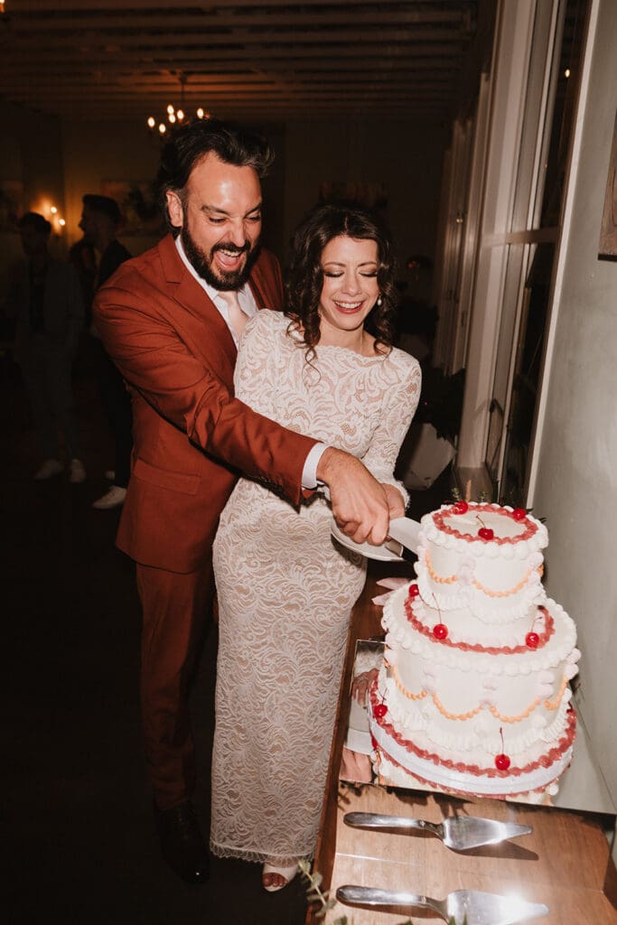 cute picture of the newlyweds cutting their wedding cake