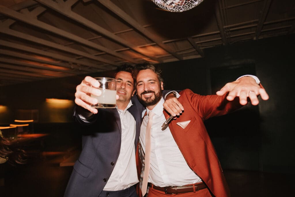 groom and his friends having the best time at the wedding reception party
